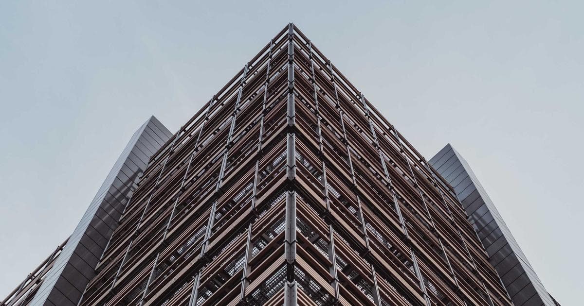 Black newcomer in Canada, looking empowered, with diverse community members in background, symbolizing support against r