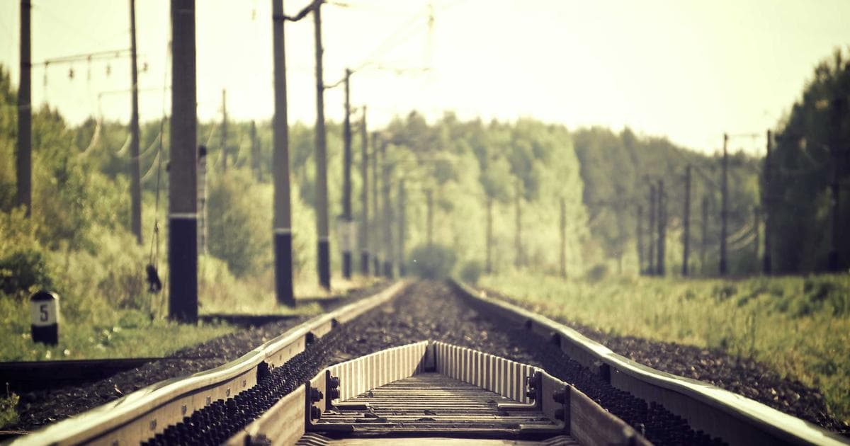 Student studying IELTS materials with a laptop and books, preparing for Canadian immigration.