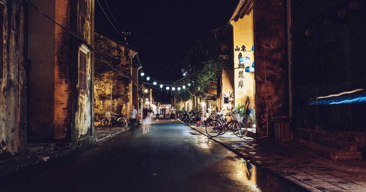 Diverse group of new citizens proudly taking the Canada Citizenship Oath with a Canadian flag.