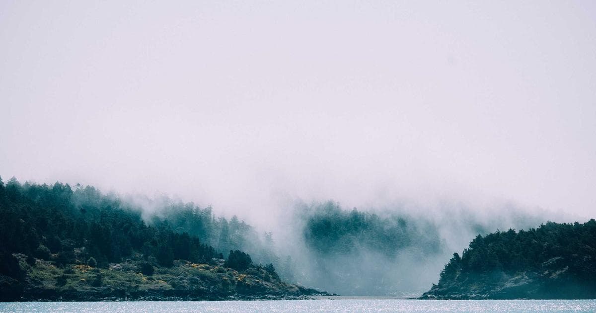 A traveler holding a Canadian visa and passport at an airport terminal
