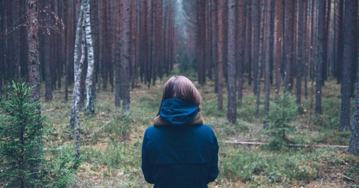 Traveler holding a Canadian visa and passport, symbolizing dual intent visitor applications
