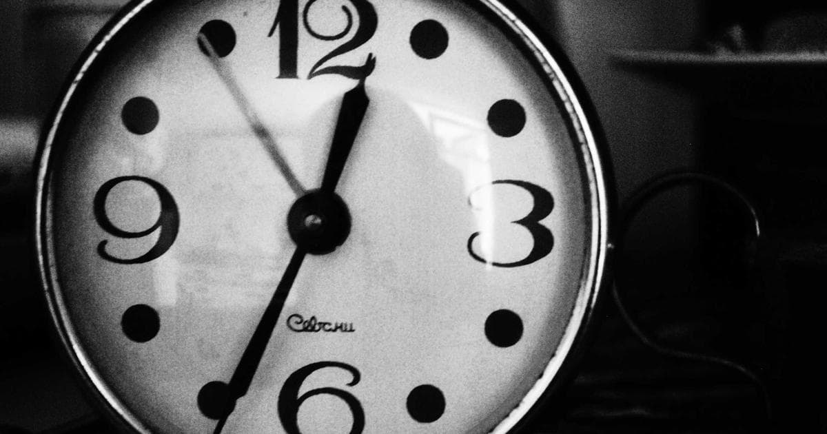 A couple walking together on a path in a Canadian park during autumn with colorful leaves