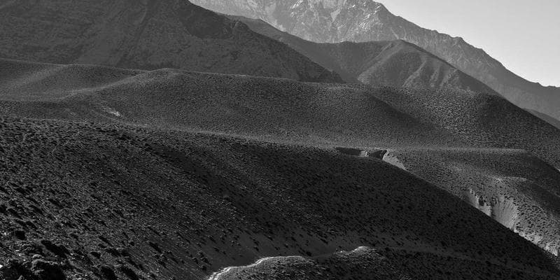 Canadian Permanent Resident card next to a passport and travel documents on a desk