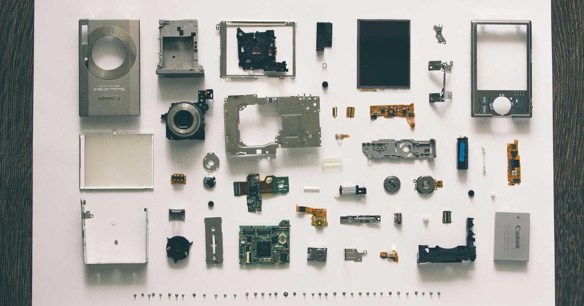 Busy urban transit hub with buses and a light rail train in a Canadian city during daytime