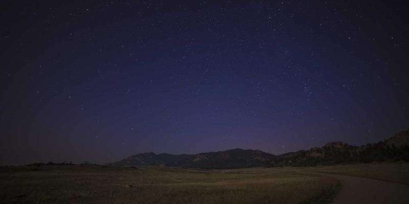 Couple smiling while walking through a Canadian city street with modern buildings