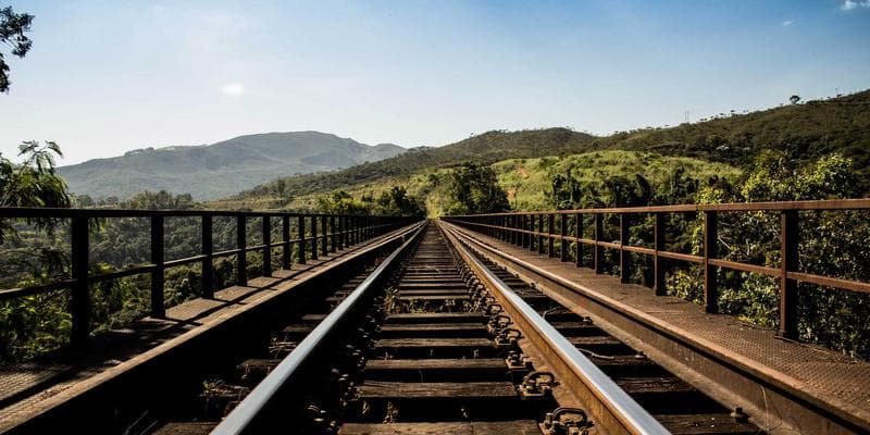 Happy family holding a Canadian Permanent Resident Card with a Canadian flag in the background, symbolizing PR card renewal.