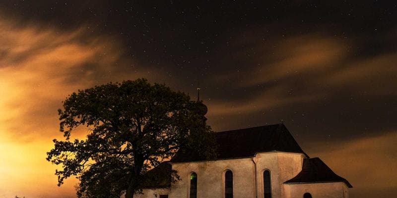 Newcomer studying IMM 5267 application forms at a desk