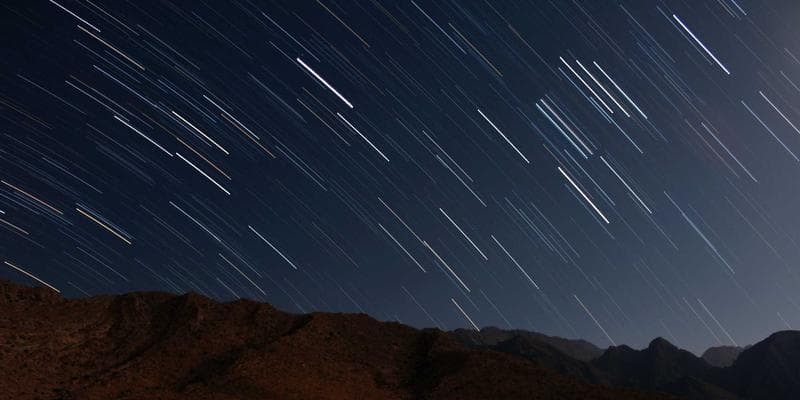Construction workers on a job site with a Canadian flag, symbolizing demand for skilled trades
