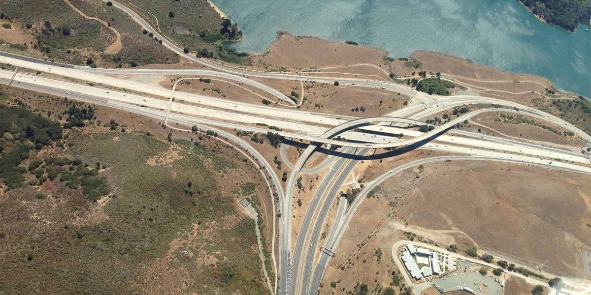 A newcomer opening a TFSA account on a laptop at a Canadian bank branch