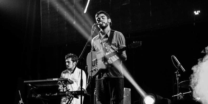 Close-up of hands filling out a government form, with a pen and glasses nearby, emphasizing accuracy in application