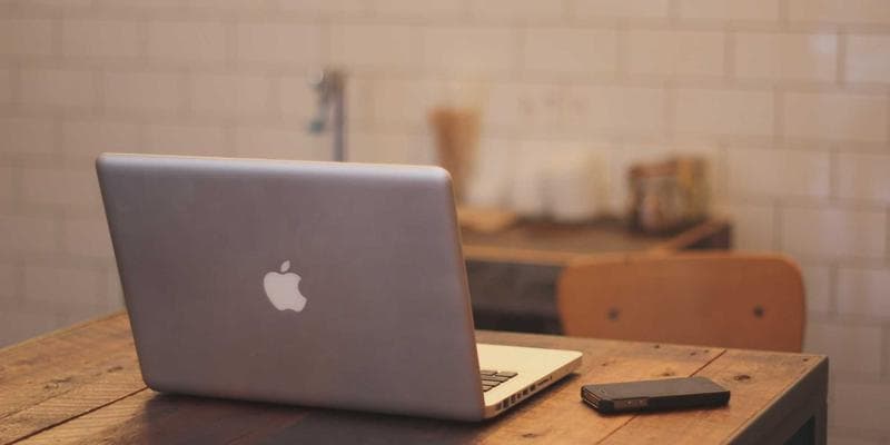 Diverse group of people smiling and interacting, symbolizing community and support for newcomers.
