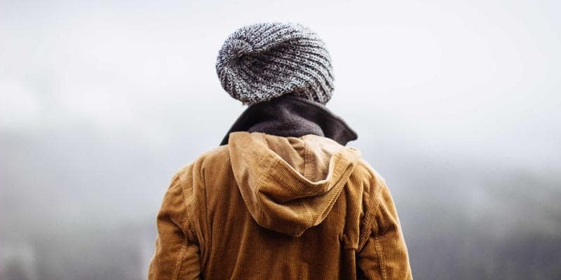 Diverse group of people smiling, symbolizing community support for newcomers