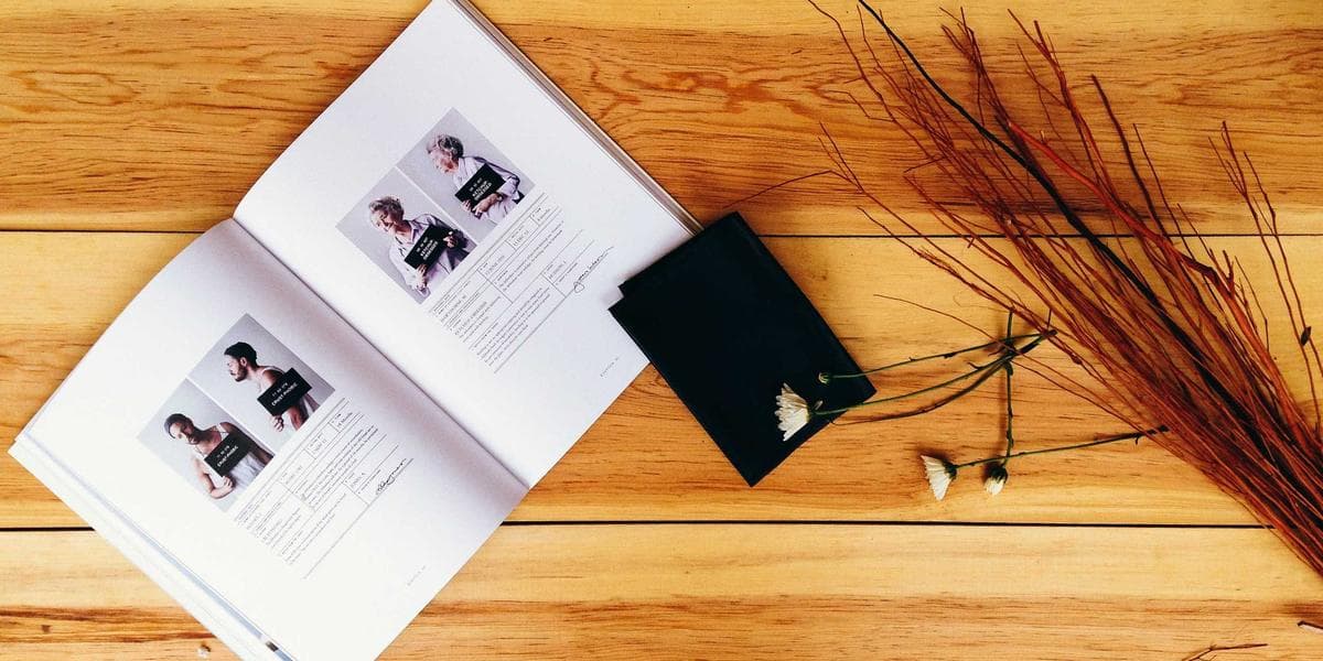 Hunter in safety orange vest walking through a Canadian forest in autumn