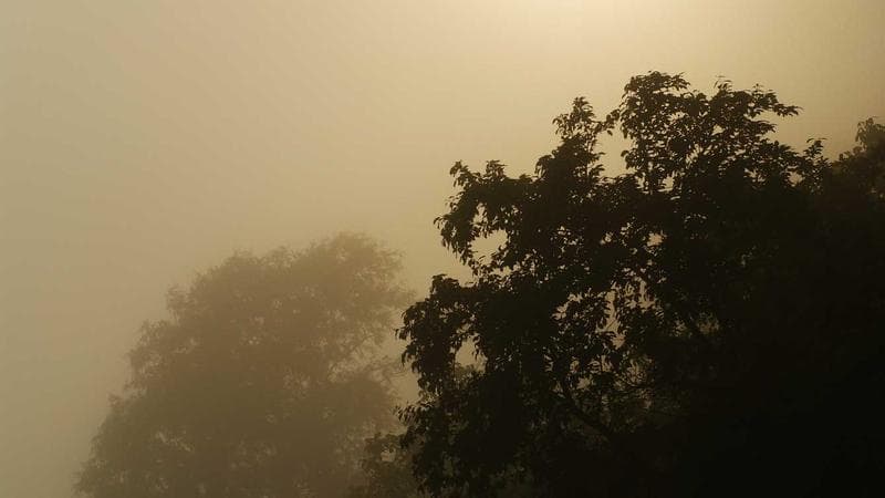 Stack of immigration documents and a Canadian passport on a desk