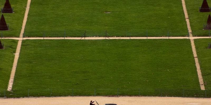 New Canadian citizens at a citizenship ceremony waving flags