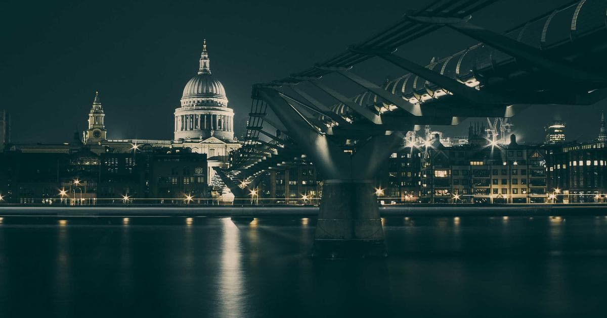 Person reviewing tax documents at a desk with a laptop and calculator