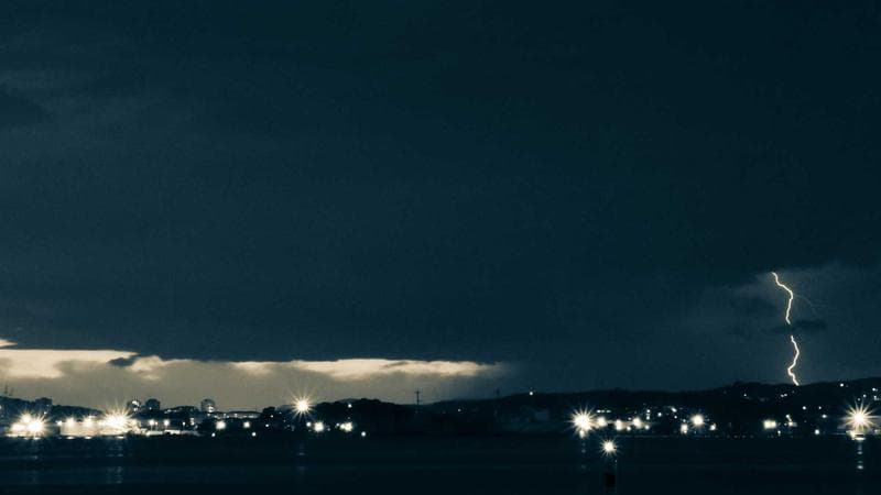 Person working on a laptop in a British Columbia café with mountain views through the window