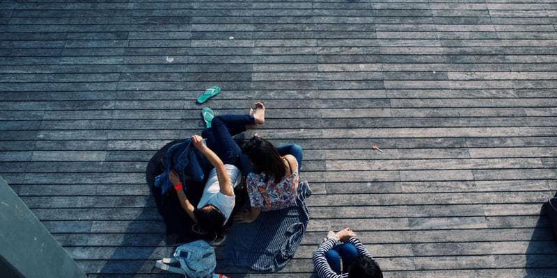 A diverse group of newcomers meeting with a housing counselor in a community office