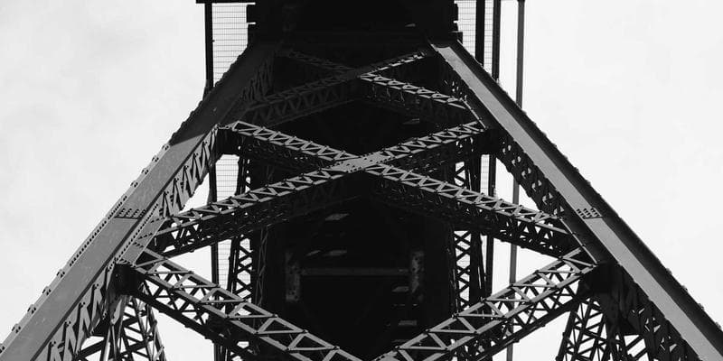 Apprentice welder learning TIG welding technique under supervision in a training facility