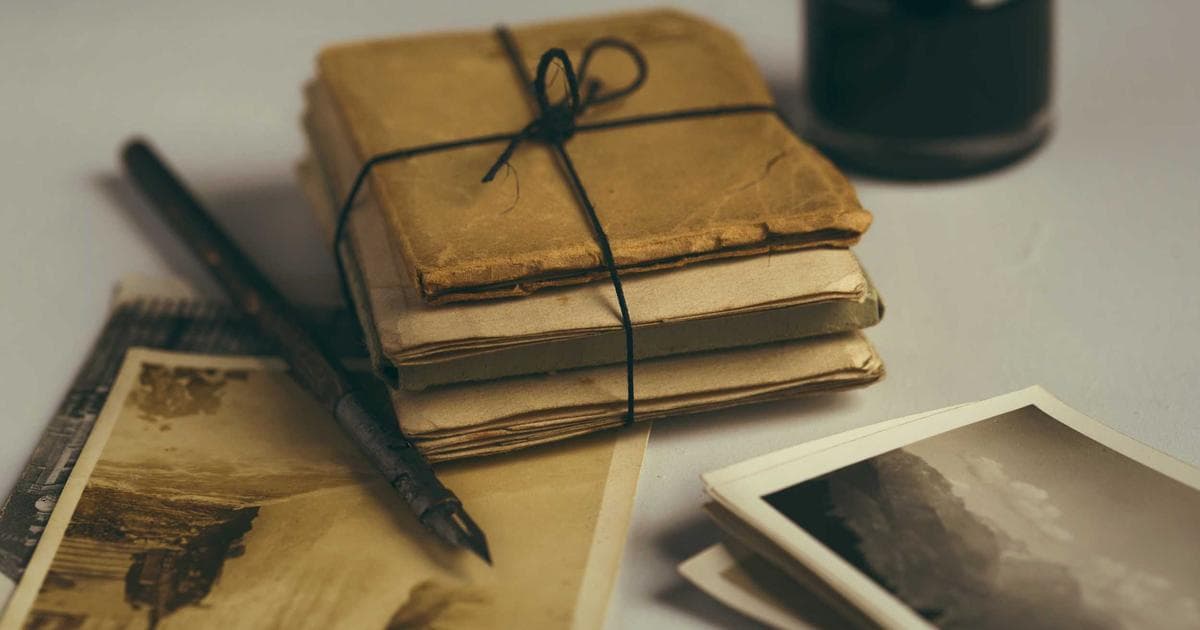 Person smiling, holding Canadian immigration documents, with a subtle Canadian flag in the background.