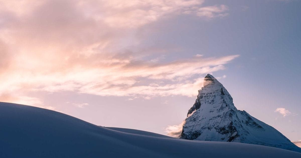 Happy couple embracing, looking at a Canadian work permit document, symbolizing family reunification.