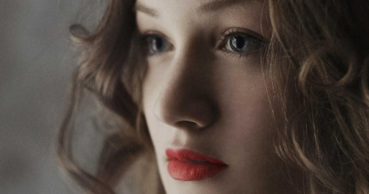 Diverse newcomer family smiling in front of their new Canadian home, holding keys, symbolizing first-time homeownership.