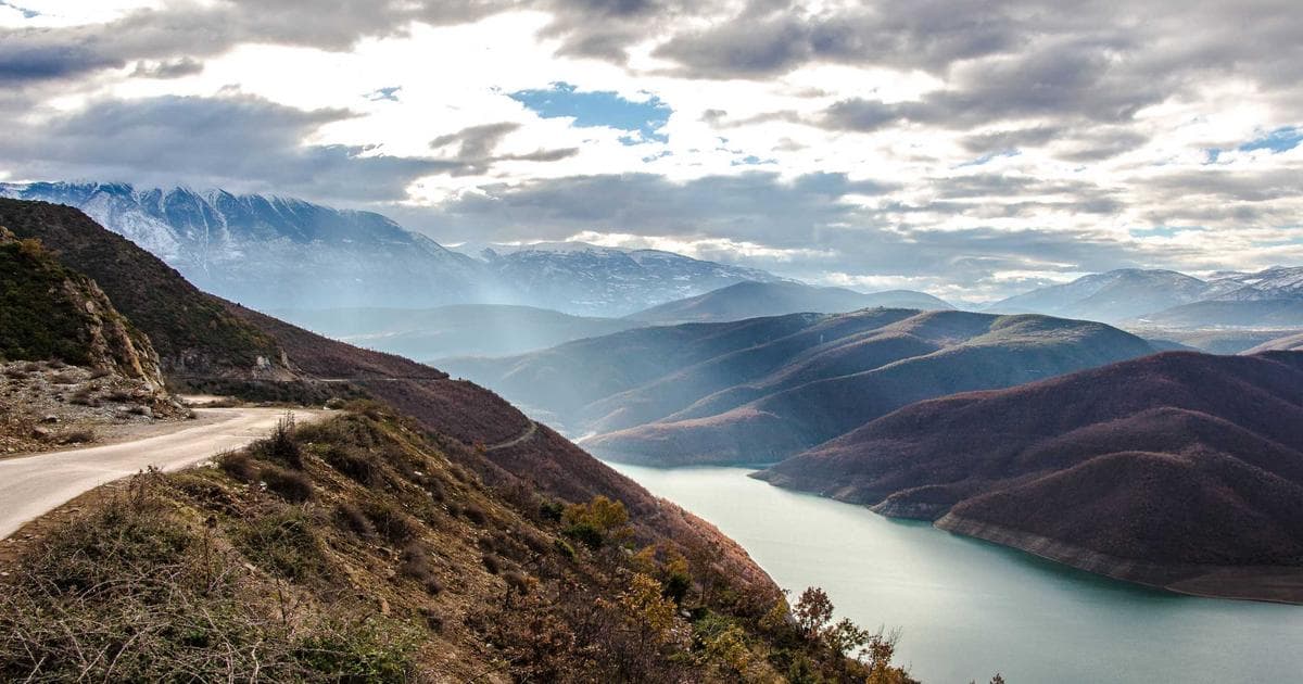 Happy couple with a Canadian flag, representing the Spousal Open Work Permit (SOWP) application process.