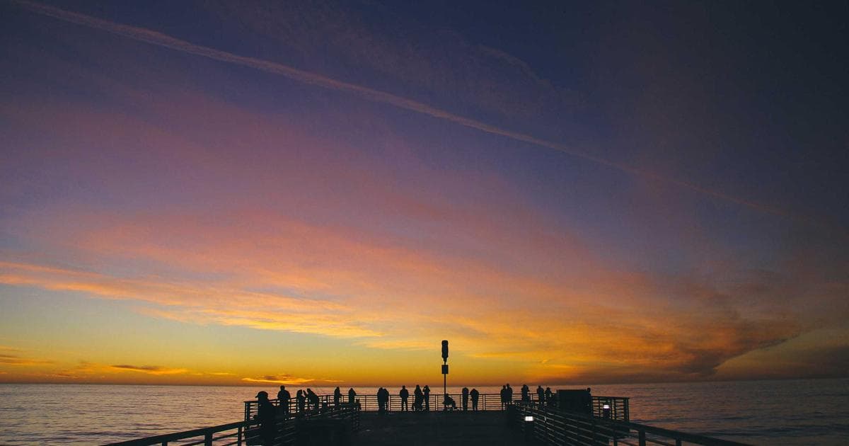Diverse group of newcomers in a classroom, actively learning English through the LINC program in Canada.