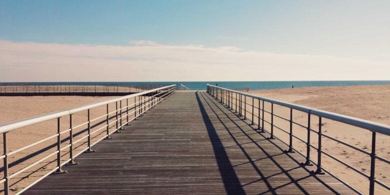 Young child reading a picture book in a cozy childcare reading corner