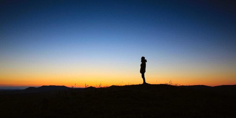 Modern condo building in Canadian city with newcomer reviewing strata documents