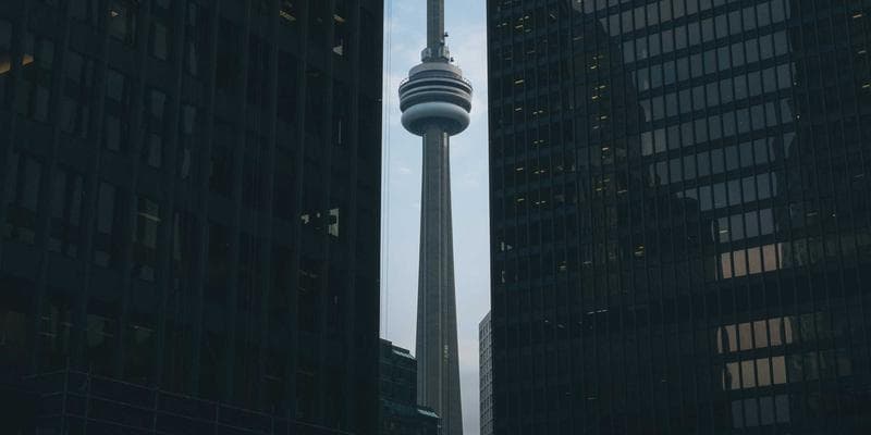 Diverse group of newcomers in Canada learning about financial planning, with a calendar showing 2026 dates and Canadian flags.