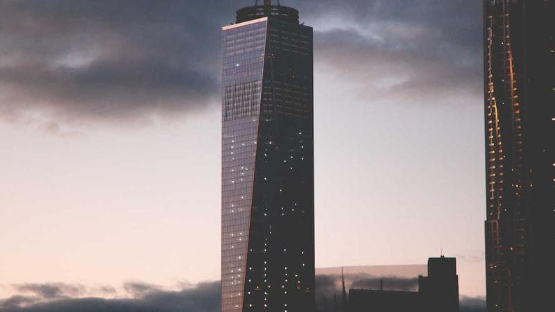 Person working on tax documents with calculator and laptop