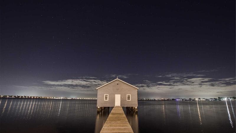 Person working on a budget with a calculator and financial documents