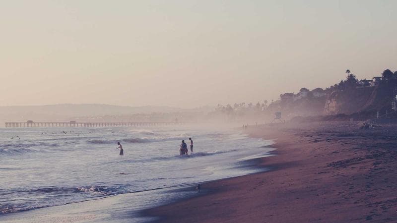 A house with a for-sale sign representing home buying in Canada for newcomers