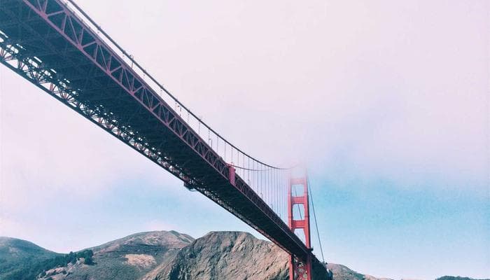 Happy retired couple walking together in a Canadian park during autumn