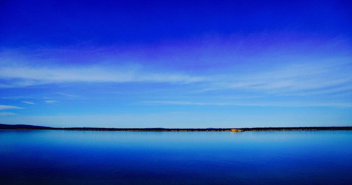 Person working on a laptop filling out an online application form