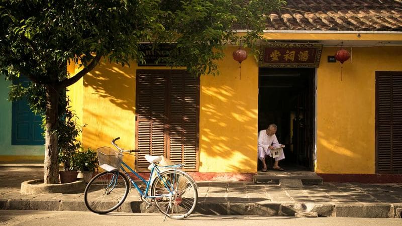 Person holding a smartphone in a Canadian city representing mobile phone plans for newcomers