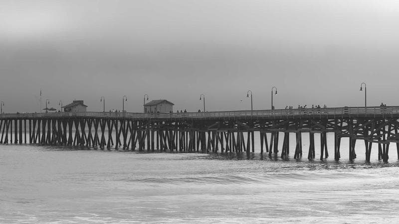 Person studying with books representing language learning challenges