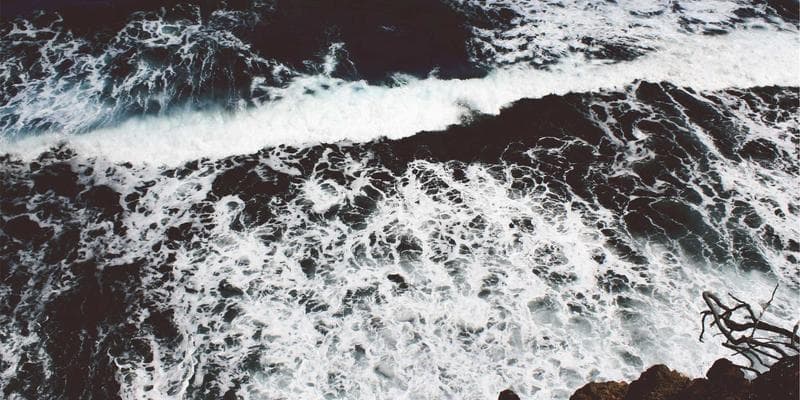 Person signing official documents with a notary stamp