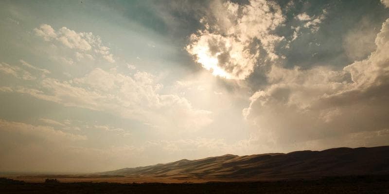 Aerial view of an Arctic landscape with a small community and industrial buildings, representing Nunavut