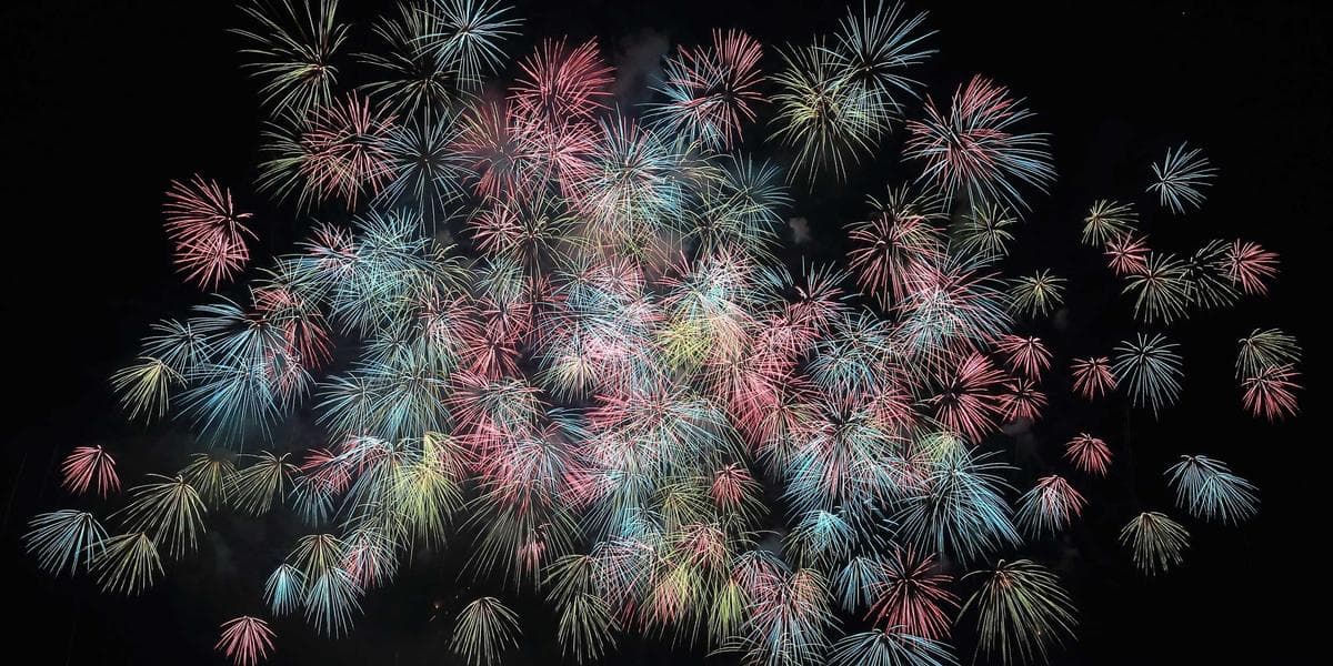 Graduate in cap and gown holding a diploma at a Canadian university convocation